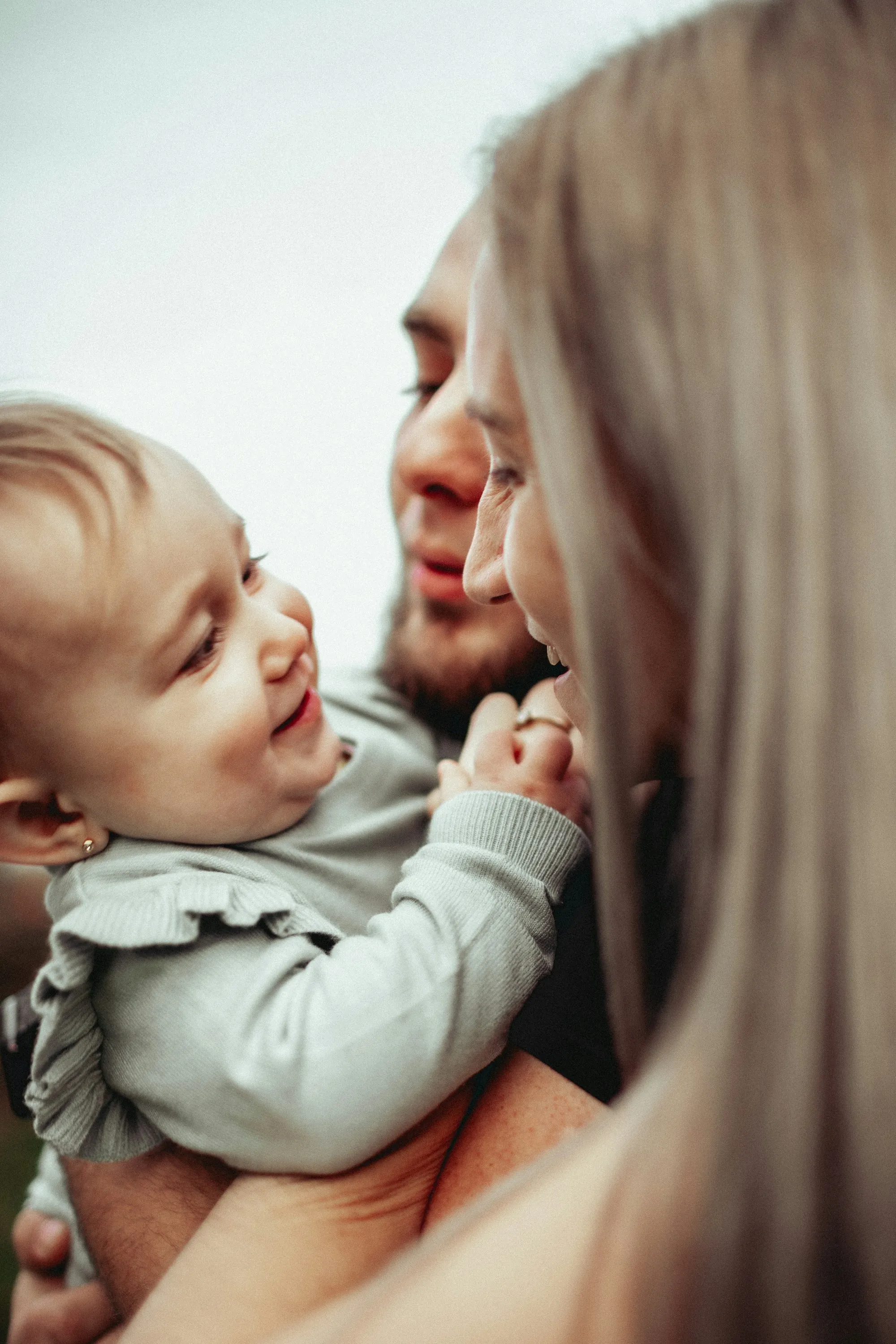 Baby smiling up at a parent