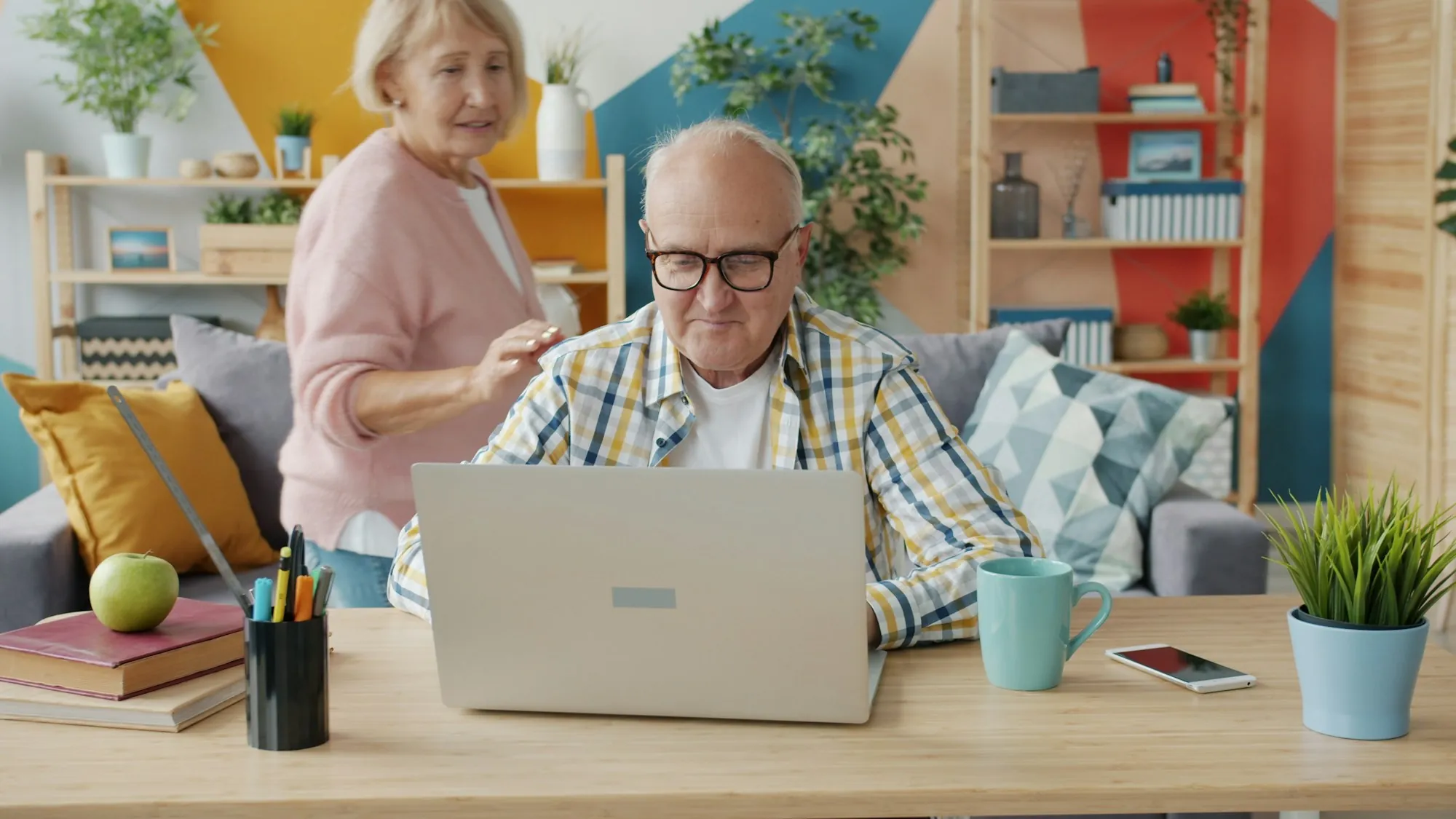 Older man using a laptop at a table