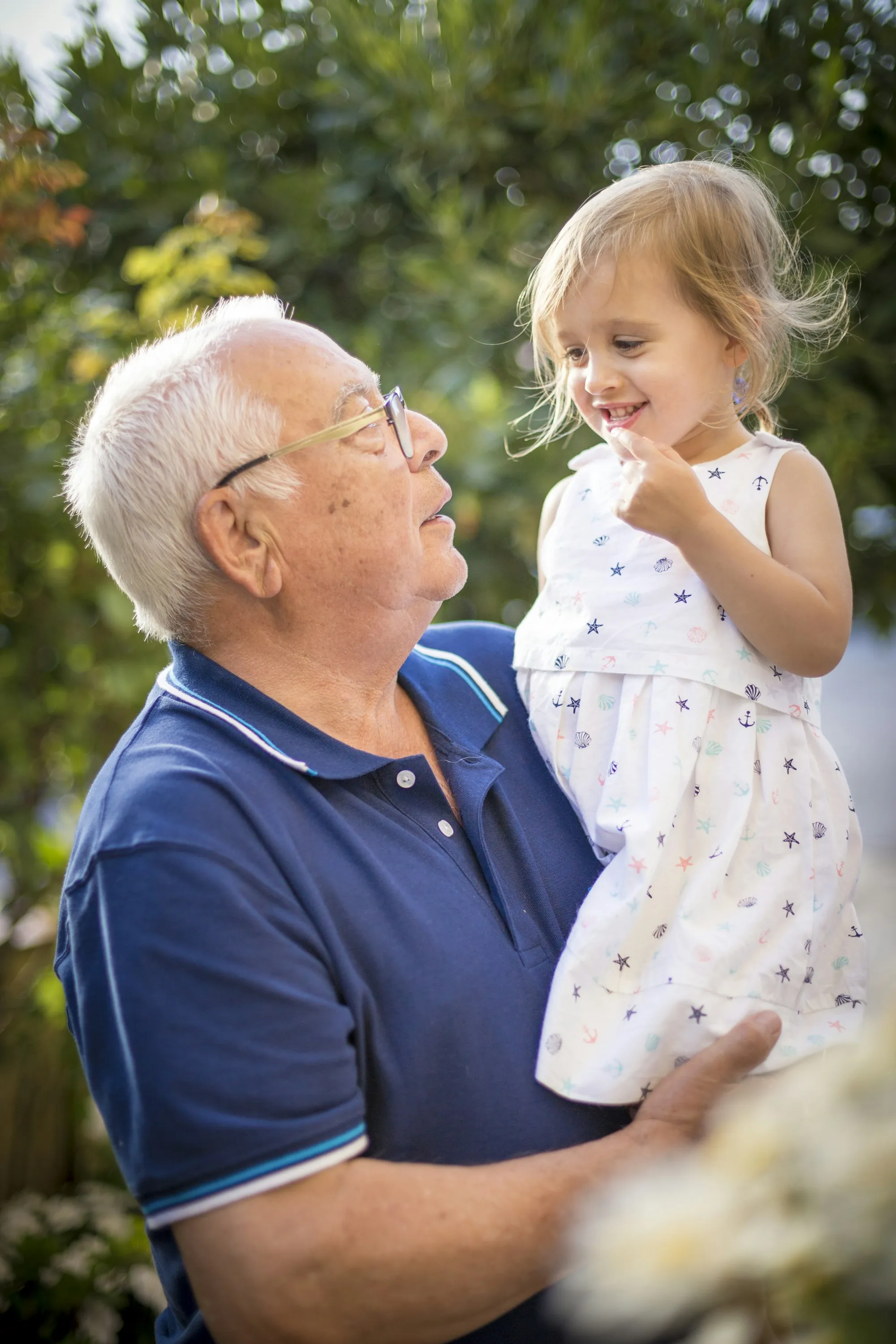 Grandfather holding his granddaughter